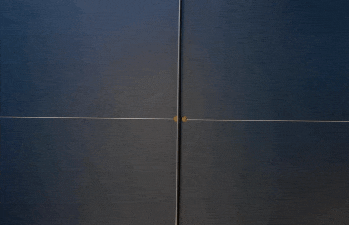 A  ping pong ball going back and forth across ping pong table